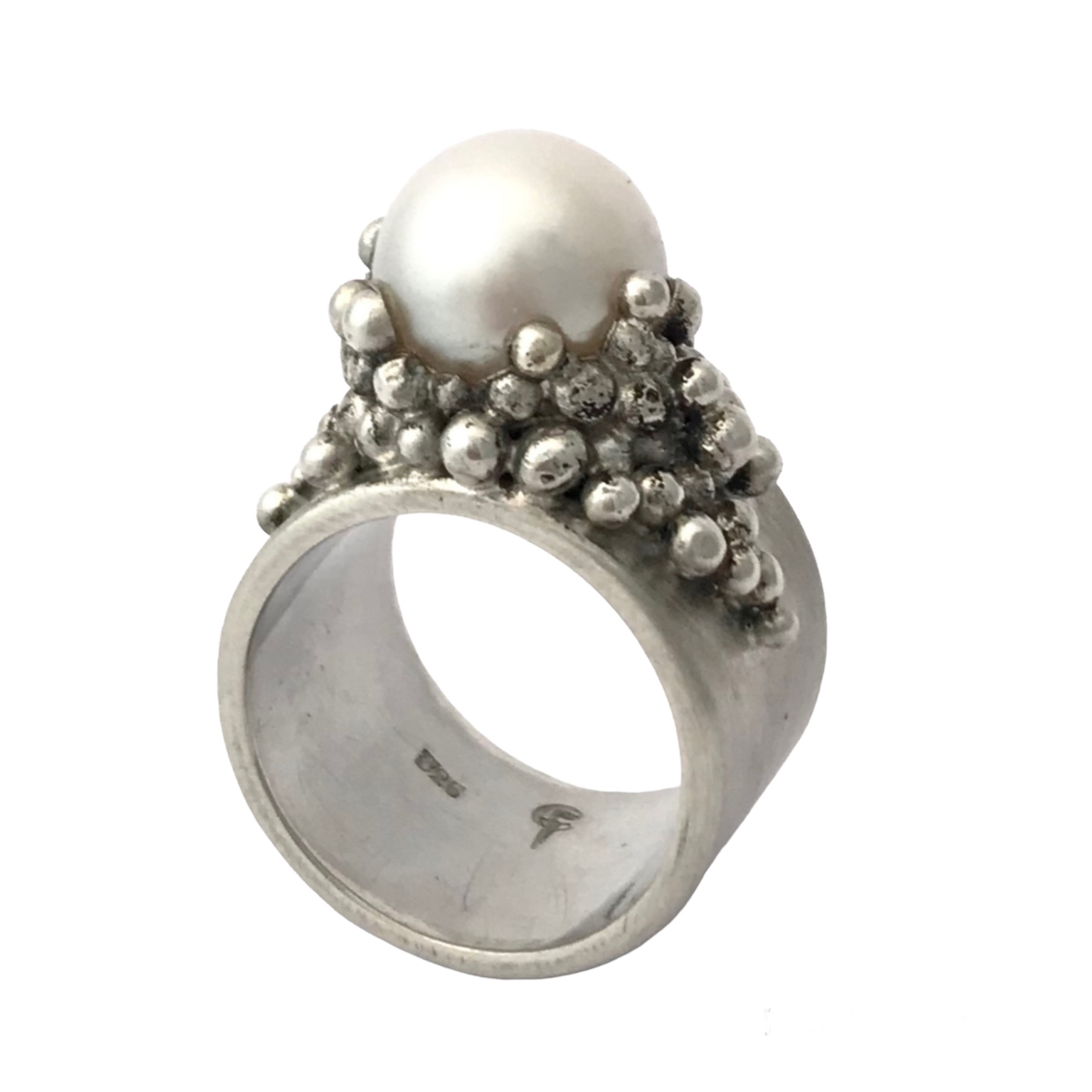 grove stoere zilveren ring met 1 hele grote witte zoetwater parel, om de parel heen zitten kleine zilveren balletjes als zetkast